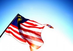 malaysia flag flying in blue sky