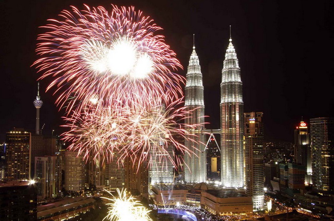 Fireworks explode near the Malaysia's landmark Petronas Twin Towers during New Year celebrations in Kuala Lumpur